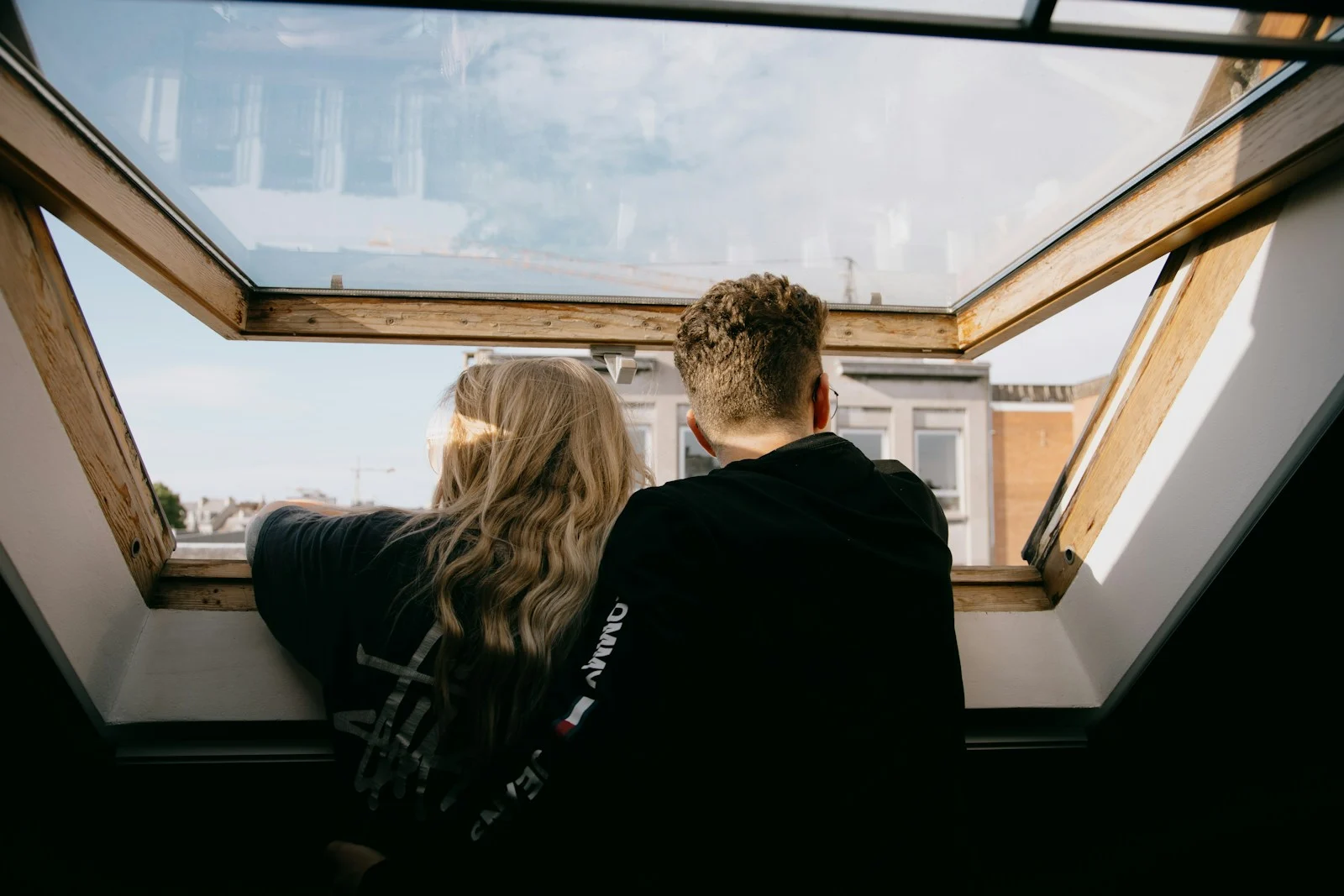 Photo by Sinitta Leunen man and woman sitting on black leather couch