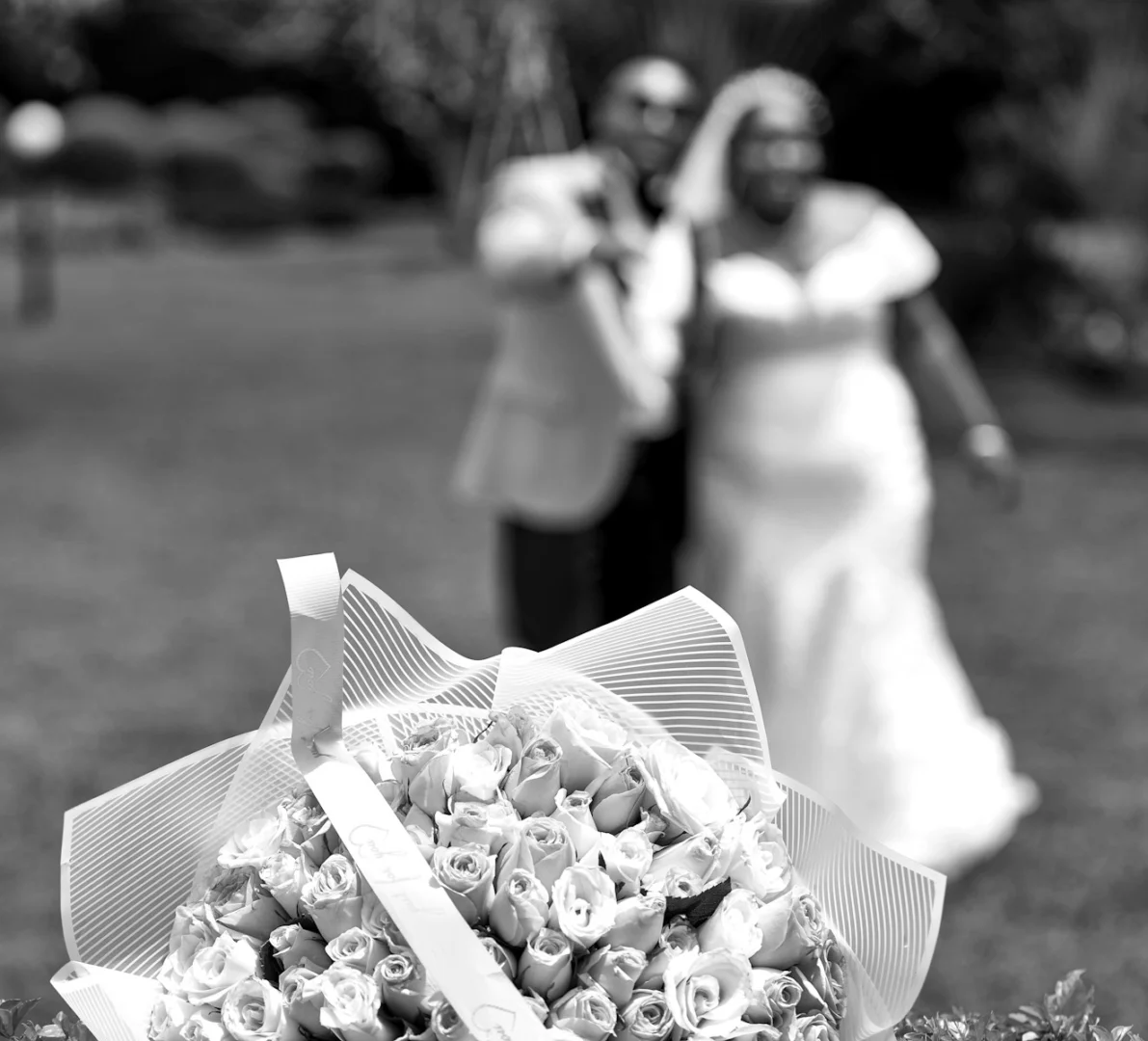 Photo by Jim Nyamao A bouquet of flowers sitting on top of a grass covered field