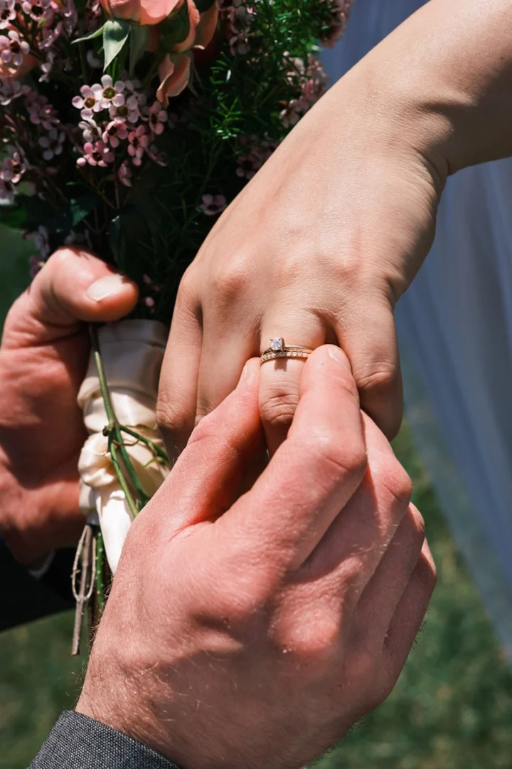 Photo by Kadyn Pierce A ring is being placed on a finger.